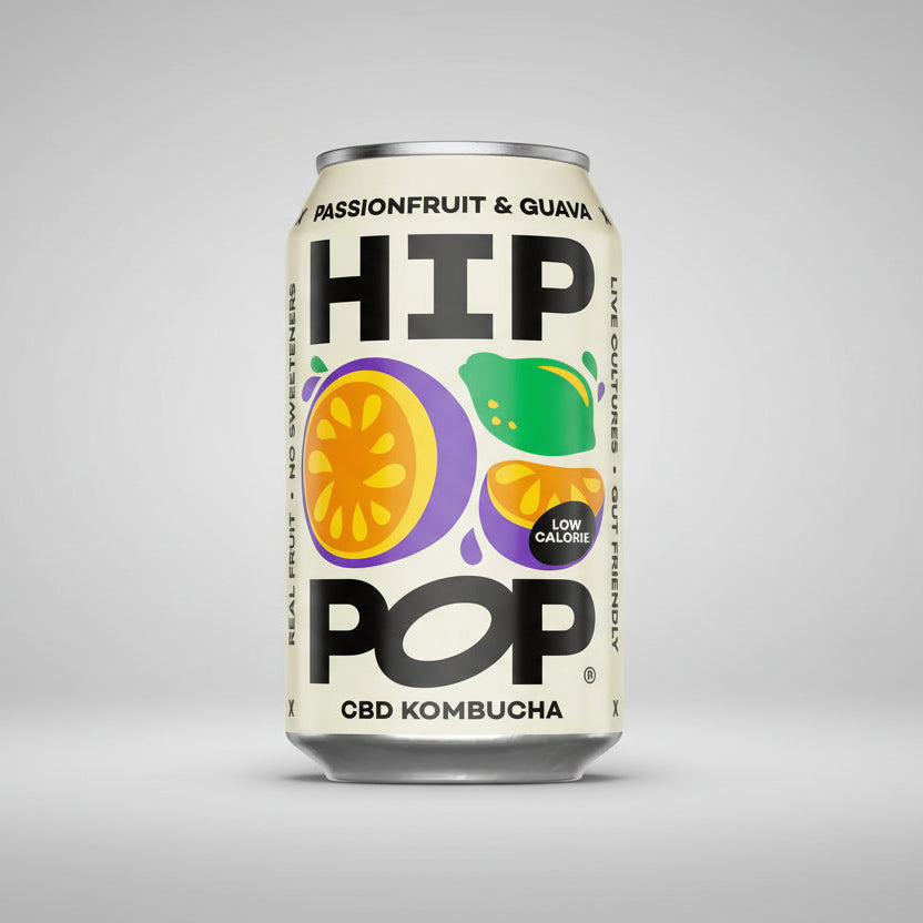 Can of HIP POP CBD Kombucha with fruit illustrations on a purple background