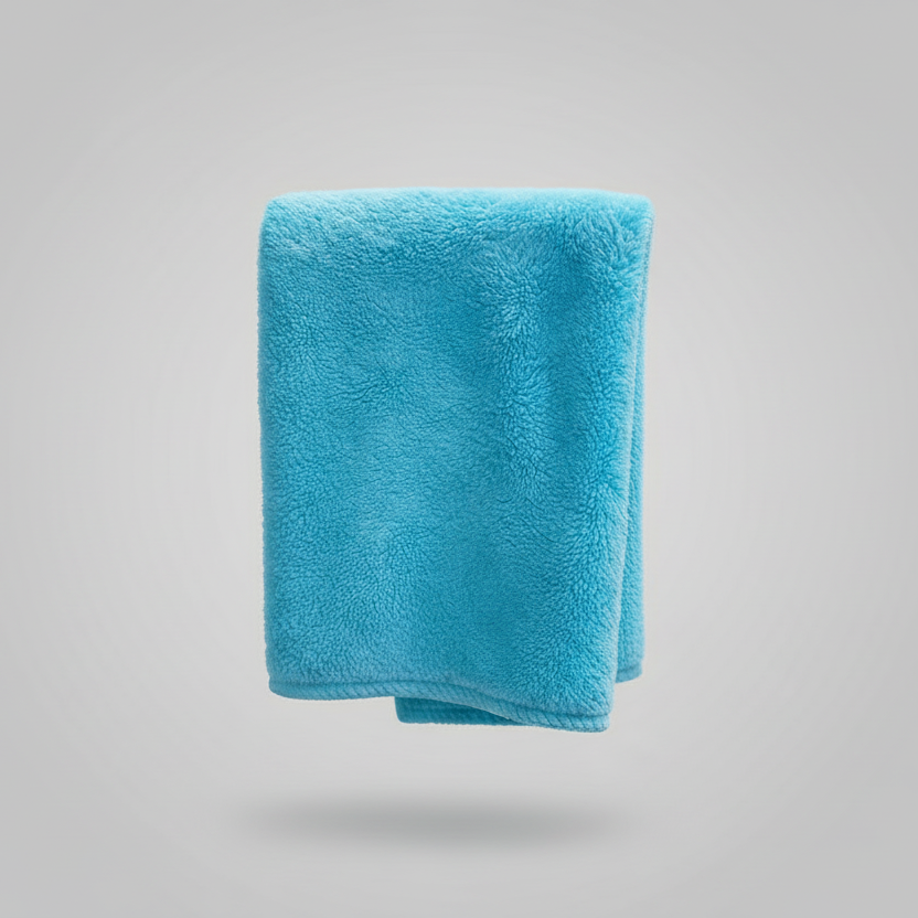 Turquoise towel hanging on a black rack against a white background